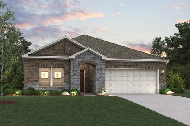 a front view of a house with a garden and yard