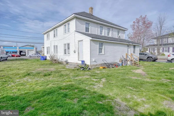 a view of a livingroom with furniture and a window