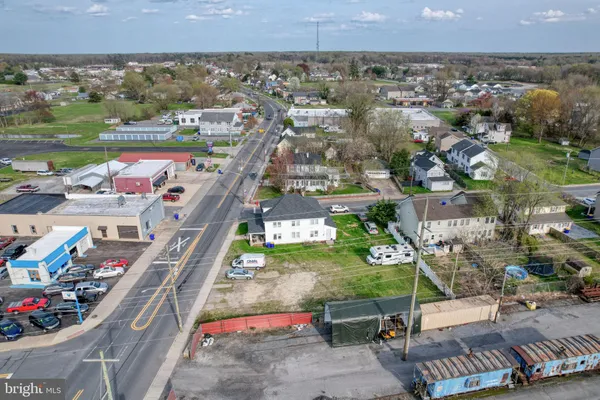 an aerial view of a house with swimming pool and big yard