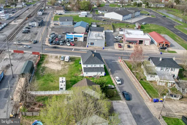 a front view of a house with a yard and potted plants