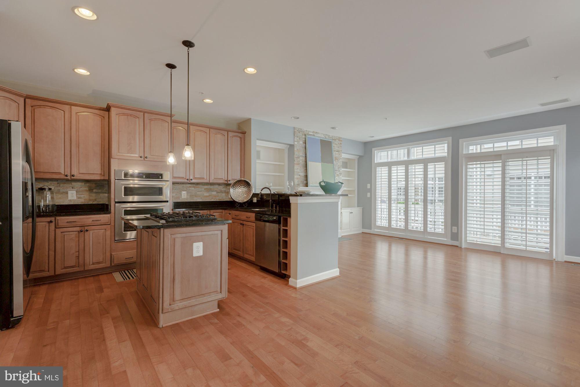 5146 Brawner Place Alexandria, VA 22304 - Photo 7 of 32 a kitchen with stainless steel appliances granite countertop a refrigerator a sink dishwasher a stove and white countertops with wooden floor