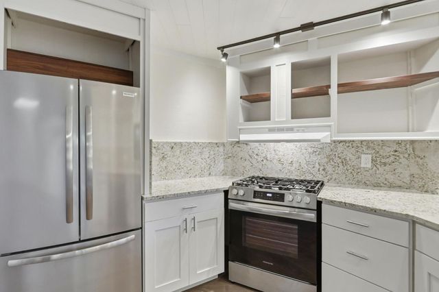 a view of a hallway with wooden shelves