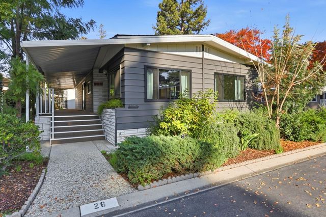 a view of a house with potted plants