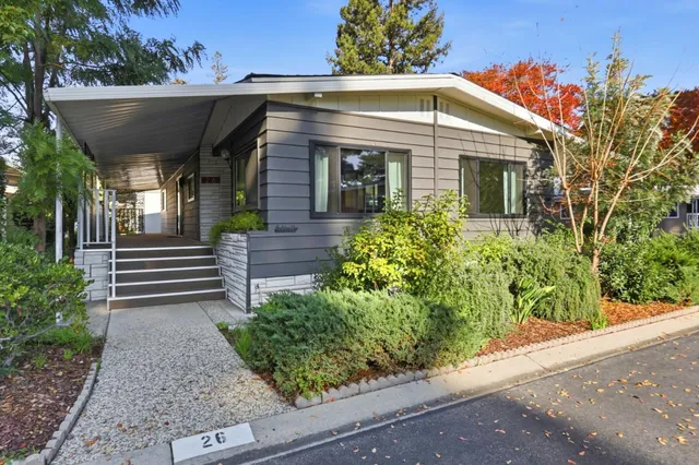 a view of a house with potted plants