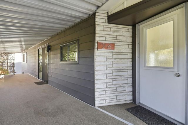 a view of a livingroom with wooden floor and windows
