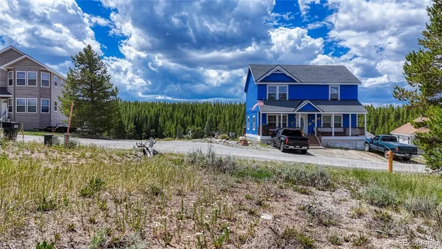 a view of house with yard and outdoor seating