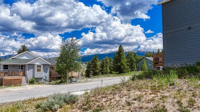a front view of a house with a yard and garden