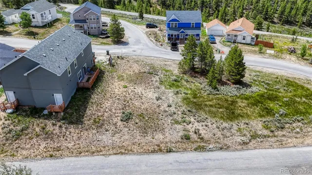 an aerial view of a house with a yard basket ball court and outdoor seating