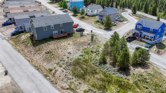 an aerial view of a house with a yard swimming pool and outdoor seating