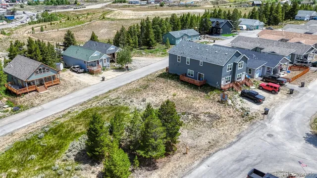 an aerial view of a house with a yard basket ball court and outdoor seating