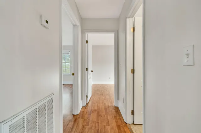 a view of a hallway with wooden floor