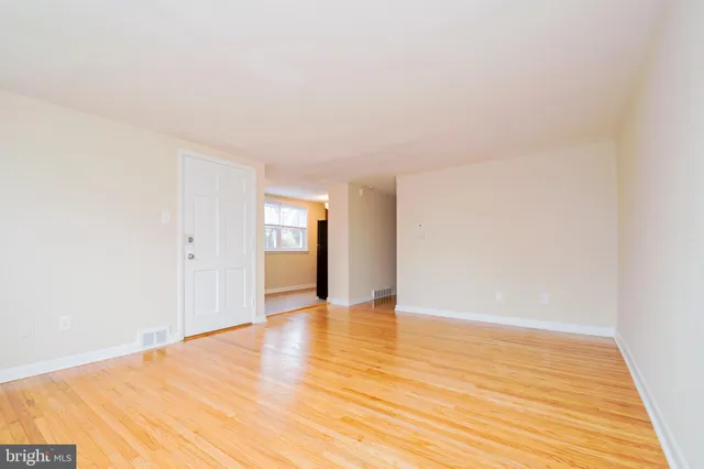 a view of an empty room and wooden floor