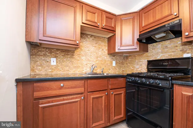 a kitchen with stainless steel appliances granite countertop a stove and a microwave