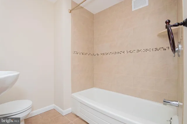 a bathroom with a toilet and a bathtub