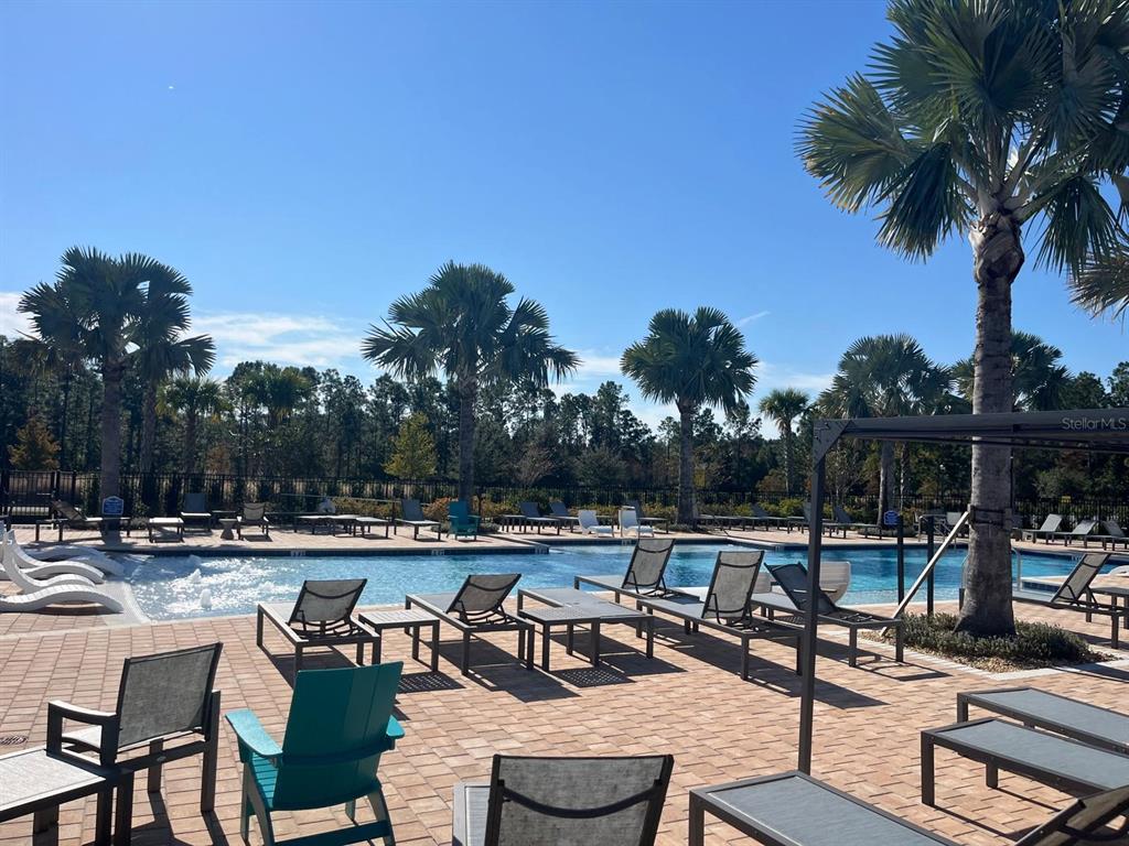 2770 Raindrop Run Street Clermont, FL 34714 - Photo 23 of 28 a view of a swimming pool with chairs