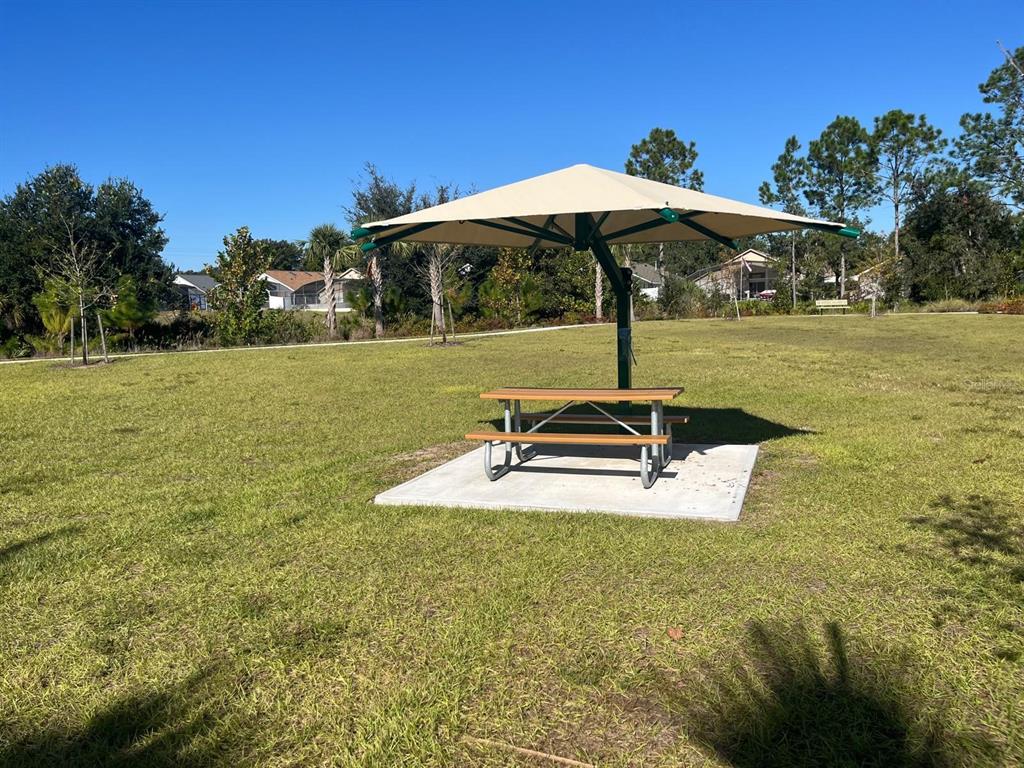 2770 Raindrop Run Street Clermont, FL 34714 - Photo 26 of 28 a backyard of a house with table and chairs