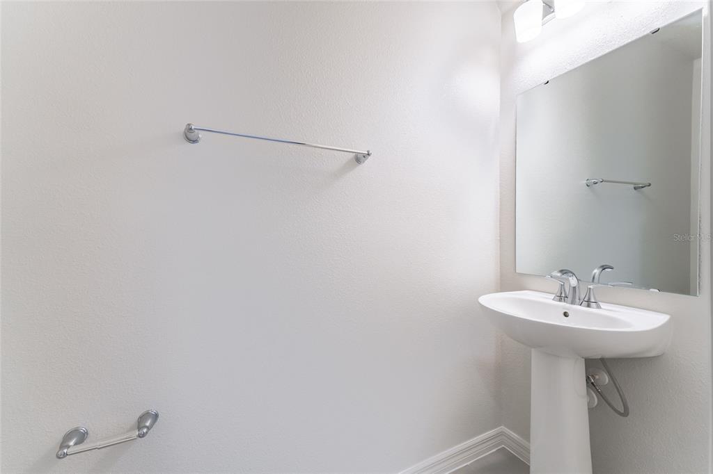 2770 Raindrop Run Street Clermont, FL 34714 - Photo 10 of 28 a bathroom with a sink and a mirror