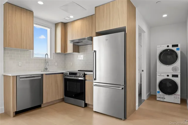a kitchen with a refrigerator sink and cabinets