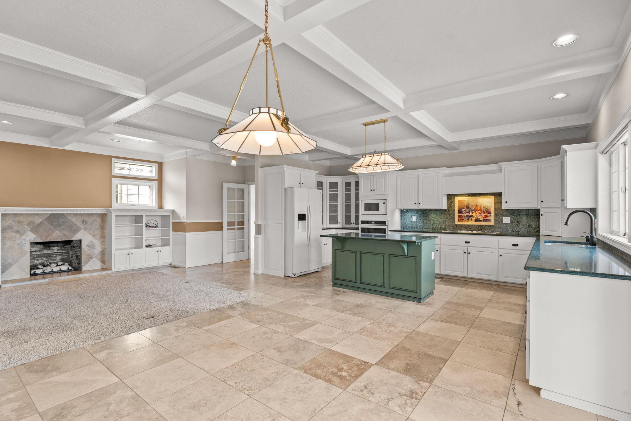 61504 Southeast Hill Ridge Road Bend, OR 97702 - Photo 18 of 70 a view of a kitchen with a sink and a living room