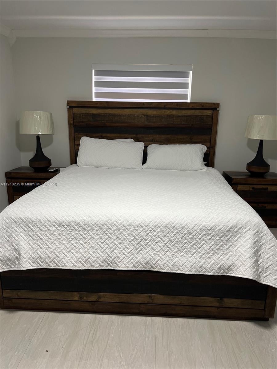 6284 Southwest 26th Street Miami, FL 33155 - Photo 13 of 25 a bedroom with a bed and a lamp