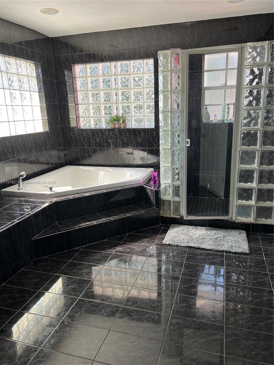 6284 Southwest 26th Street Miami, FL 33155 - Photo 14 of 25 a bathroom with a bathtub and a shower