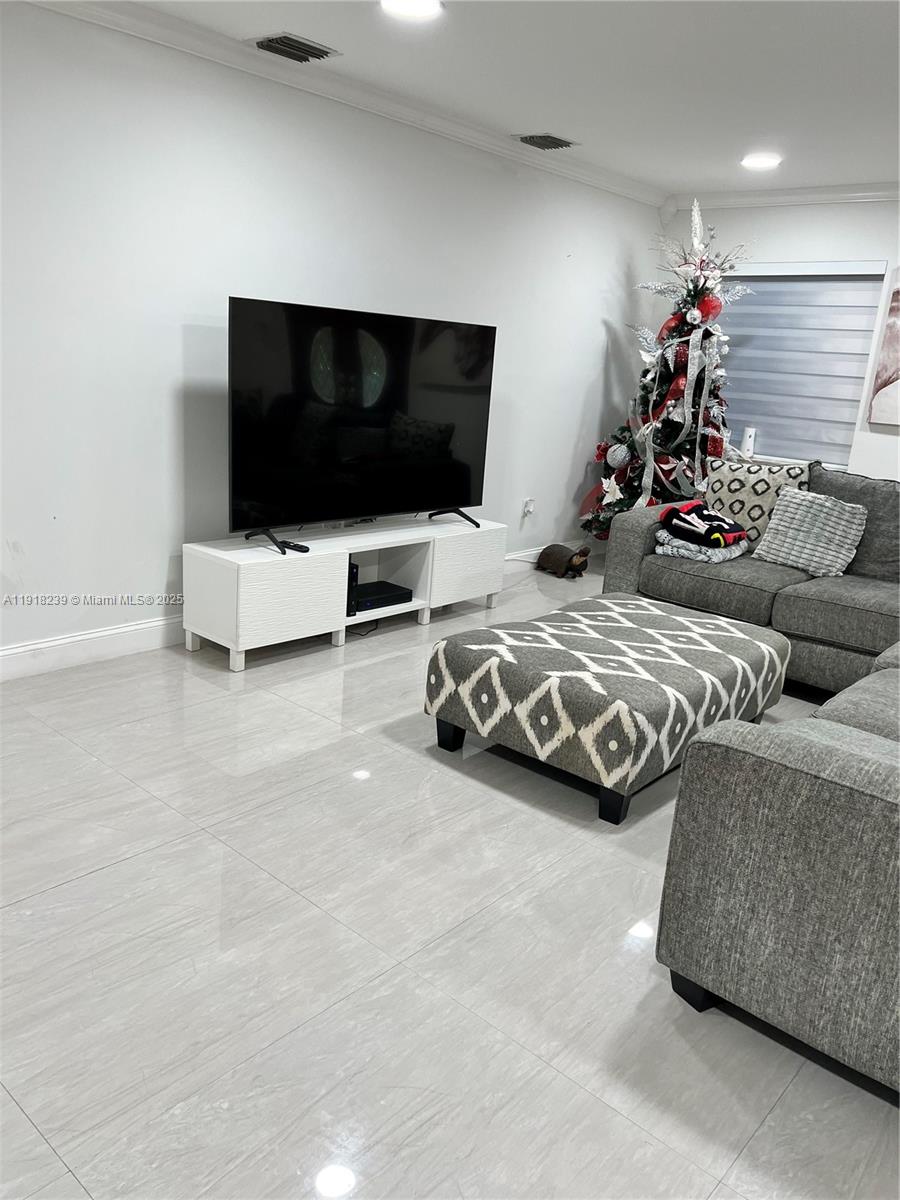 6284 Southwest 26th Street Miami, FL 33155 - Photo 15 of 25 a living room with a flat screen tv and a couch