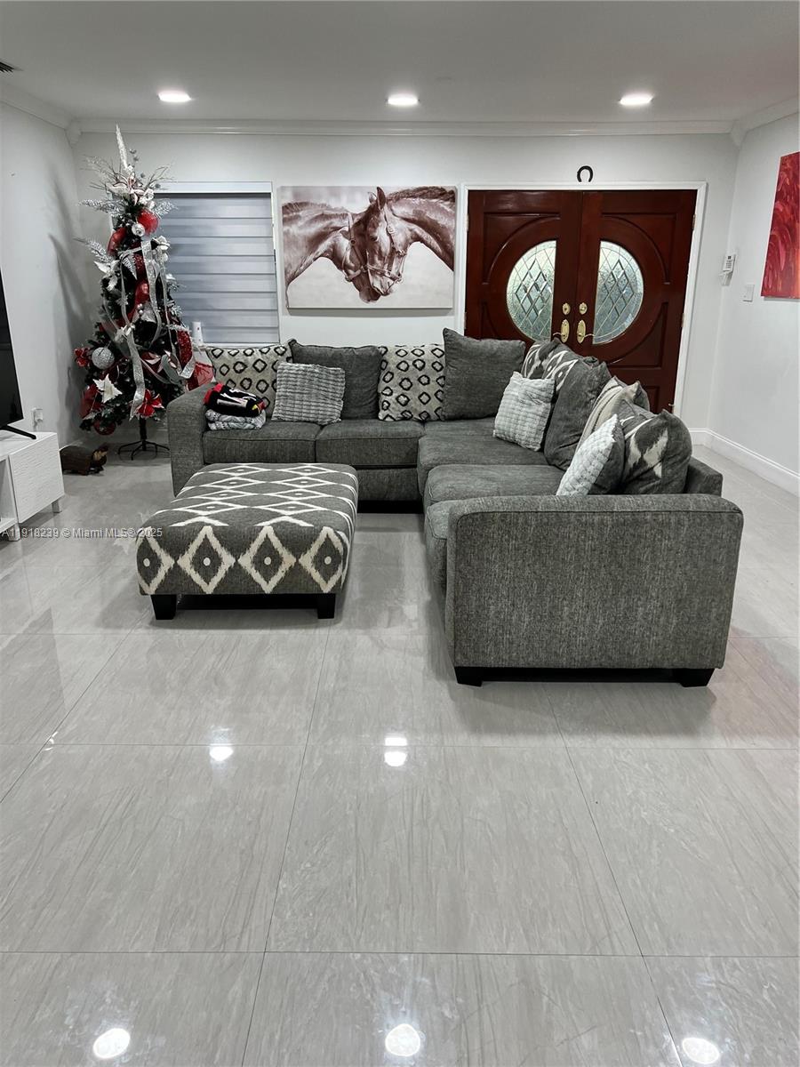 6284 Southwest 26th Street Miami, FL 33155 - Photo 16 of 25 a living room with furniture and a flat screen tv