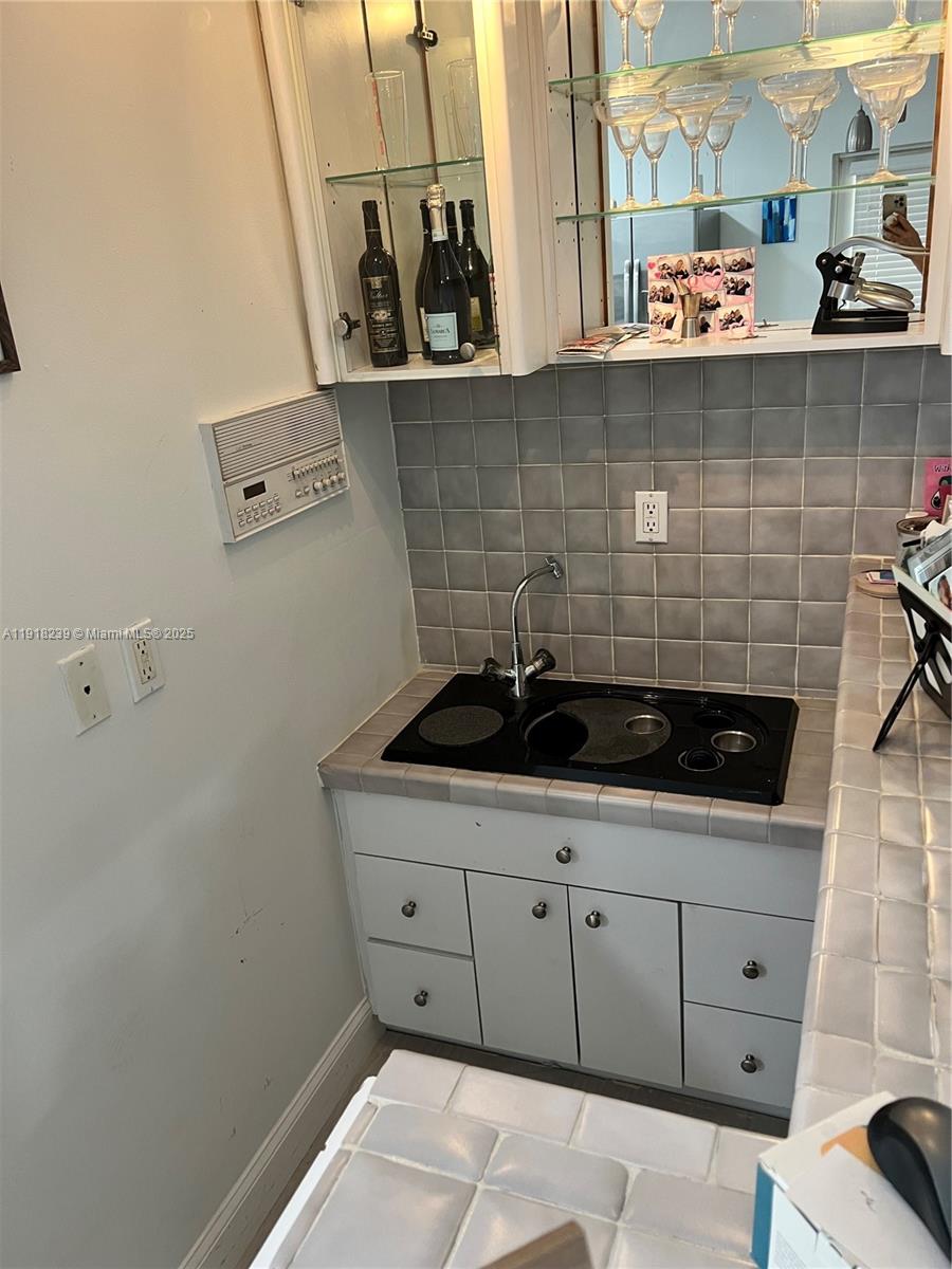 6284 Southwest 26th Street Miami, FL 33155 - Photo 23 of 25 a close view of a sink and a stove in a kitchen