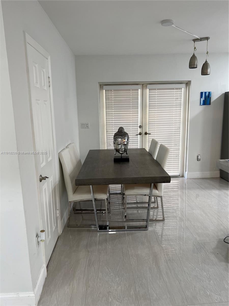 6284 Southwest 26th Street Miami, FL 33155 - Photo 10 of 25 a view of a dining room with furniture and a window