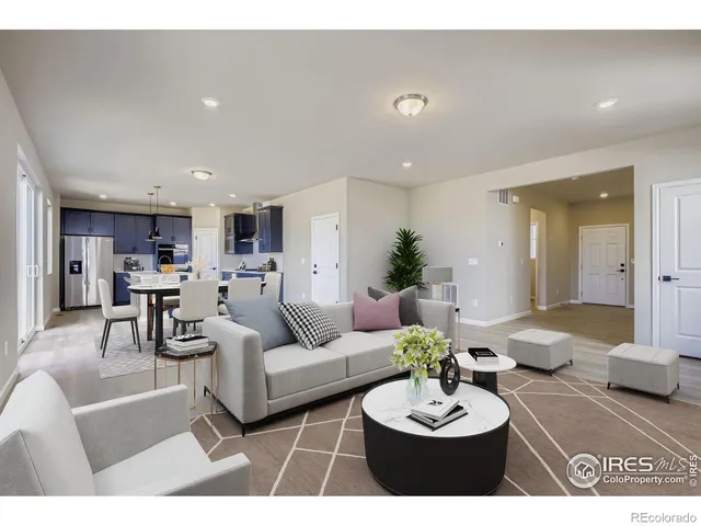 a living room with furniture and a dining table with kitchen view