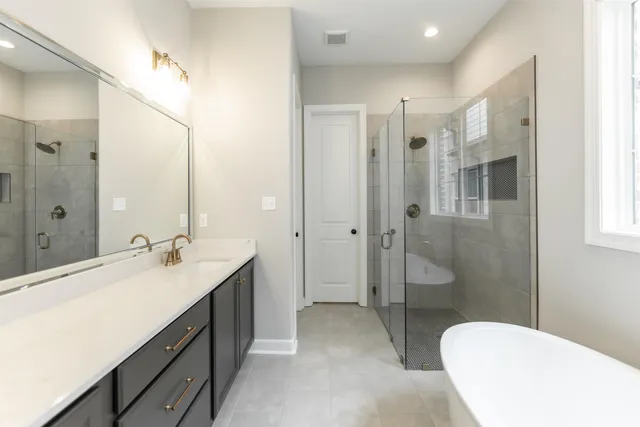 a bathroom with a double vanity sink toilet mirror and shower