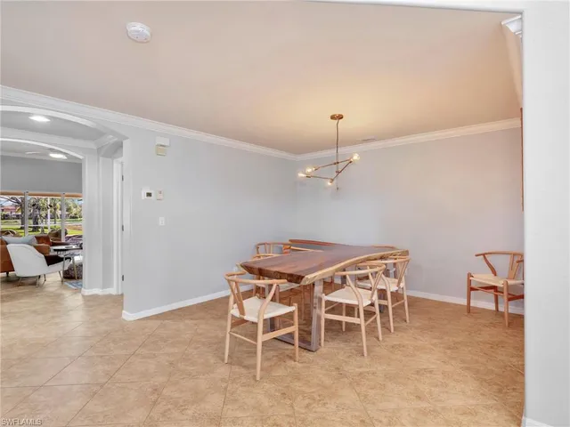 a view of a dining room with furniture and a chandelier