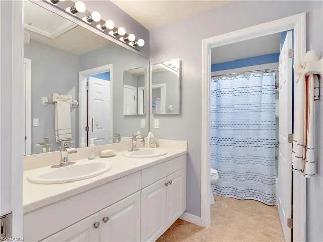 a bathroom with a sink double vanity and shower