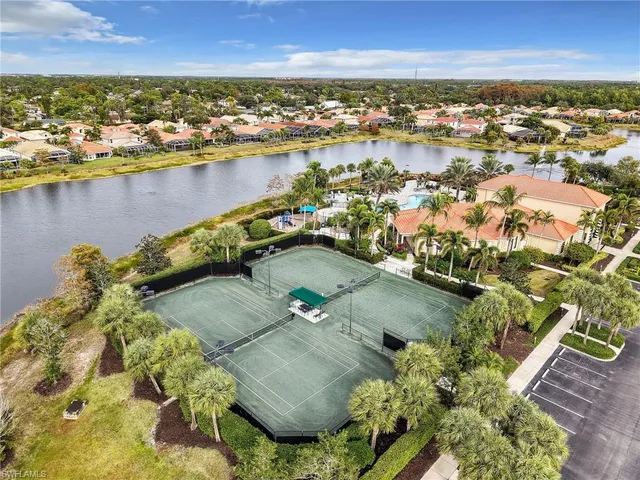 an aerial view of residential houses with outdoor space and lake view