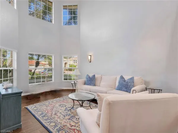 a living room with furniture and a floor to ceiling window