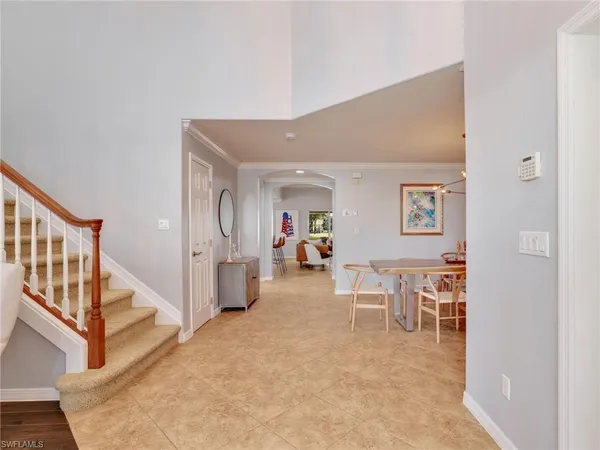 a bedroom with a bed and a chandelier fan