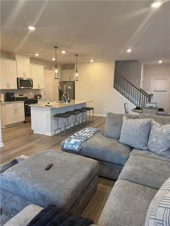 a living room with furniture and kitchen view