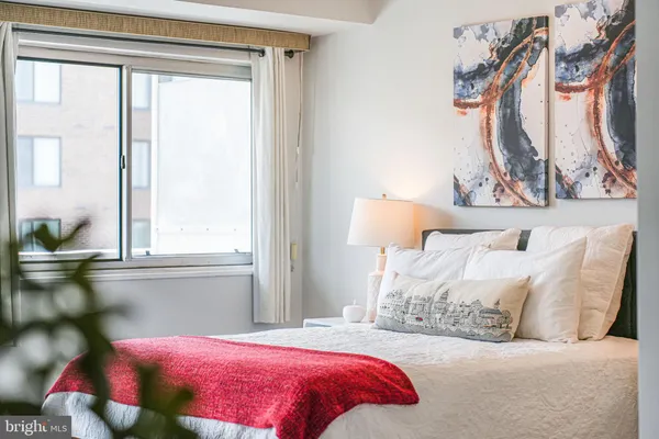 a bedroom with a bed and a window
