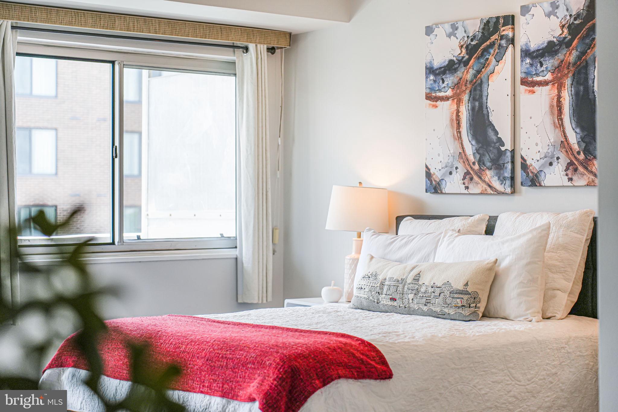 730 24th Street Northwest, Unit 612 Washington, DC 20037 - Photo 11 of 39 a bedroom with a bed and a window