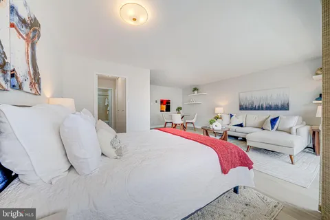 a bedroom with a bed and a couch