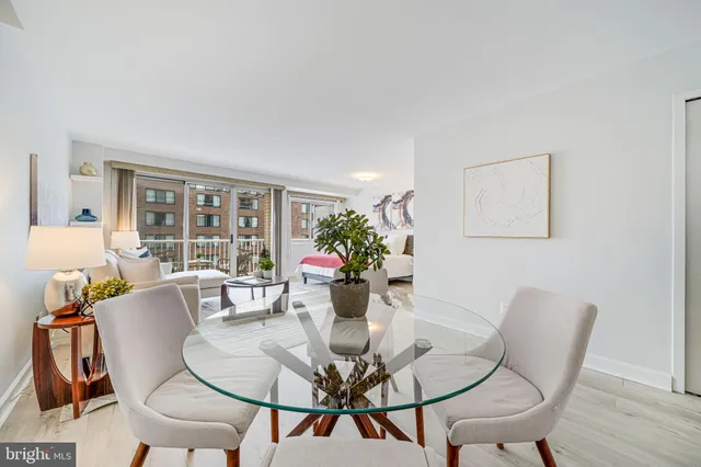 a dining room with furniture and wooden floor