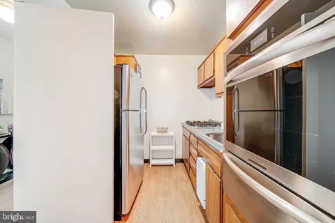 a kitchen with a refrigerator and a stove