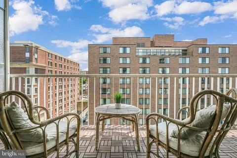 a view of a chairs and a table in the balcony