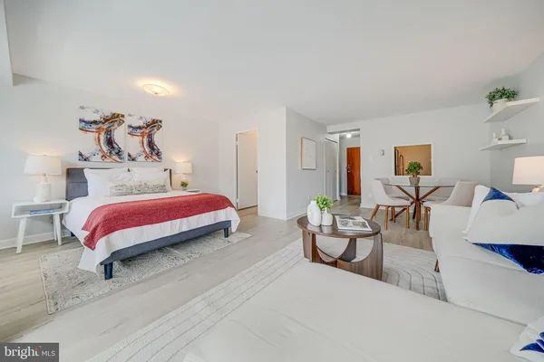 a bedroom with a bed and couch
