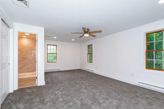 an empty room with windows and closet