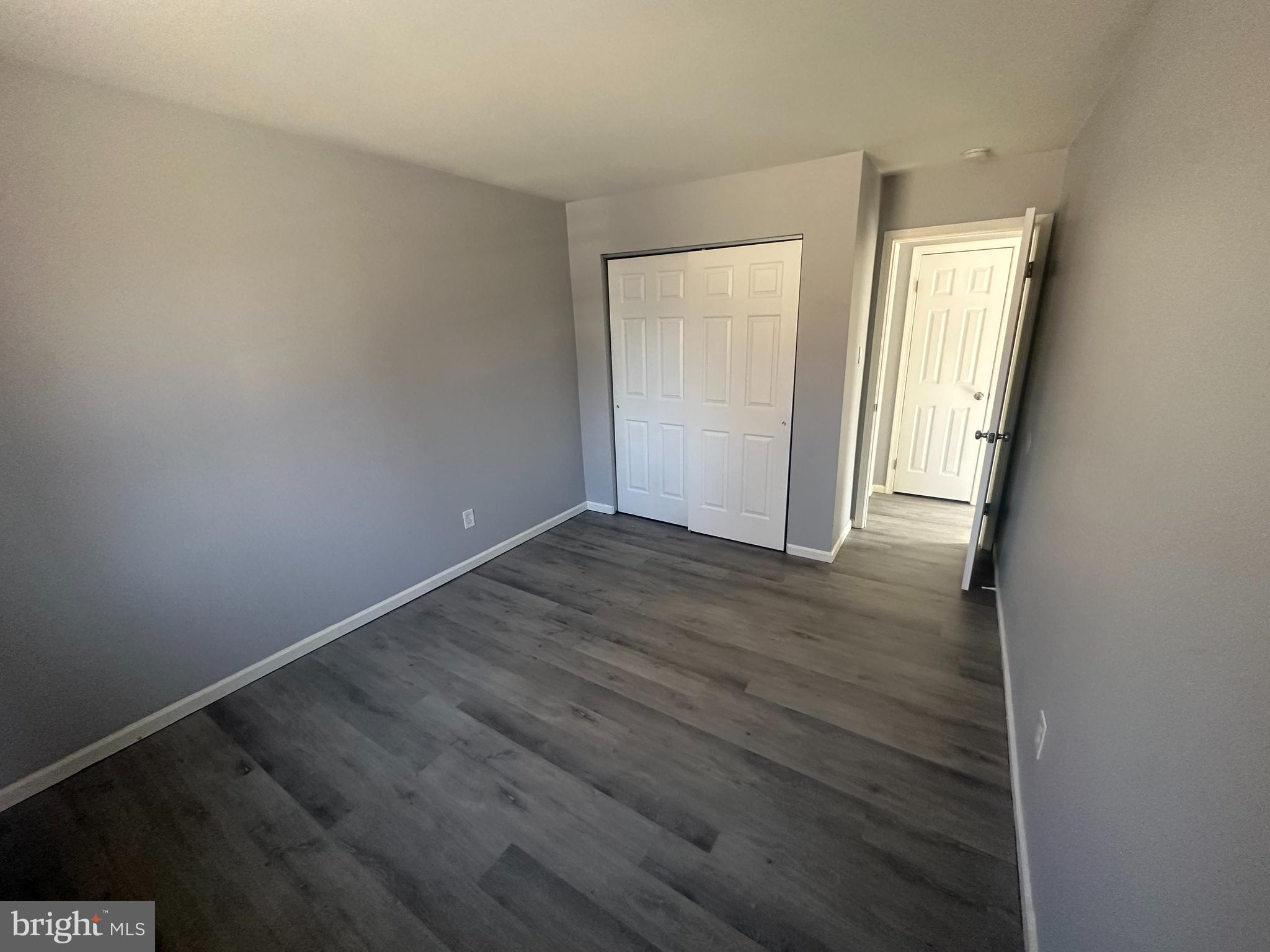 18-20 Thomas Road, Unit 18 Aston, PA 19014 - Photo 11 of 12 an empty room with wooden floor and windows