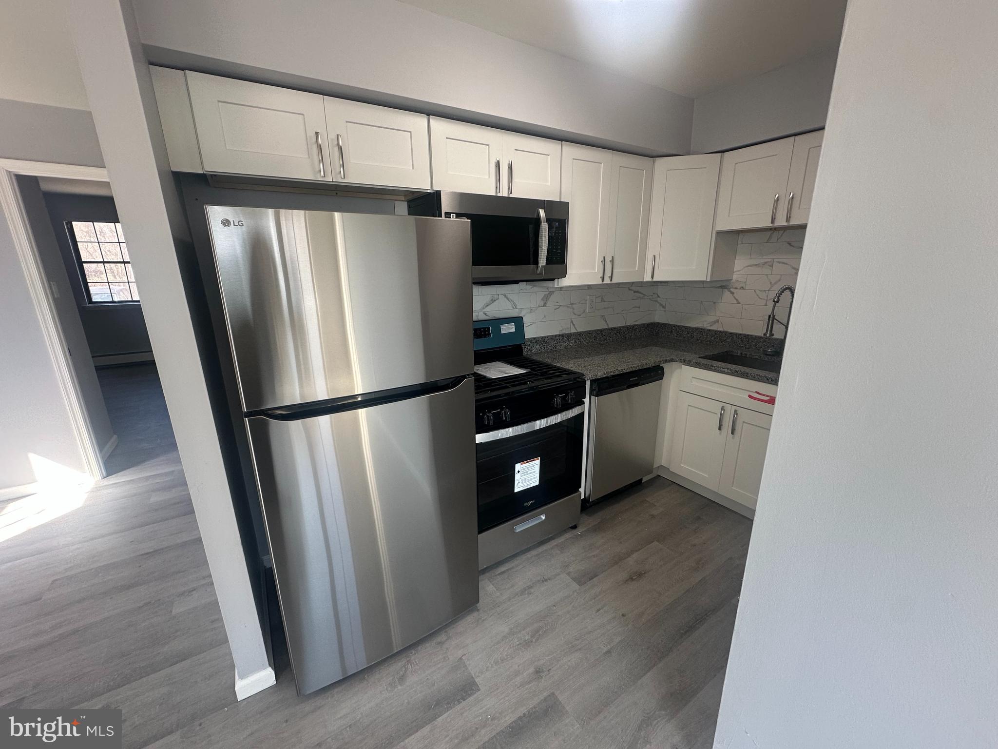 18-20 Thomas Road, Unit 18 Aston, PA 19014 - Photo 5 of 12 a kitchen with stainless steel appliances a refrigerator sink and cabinets