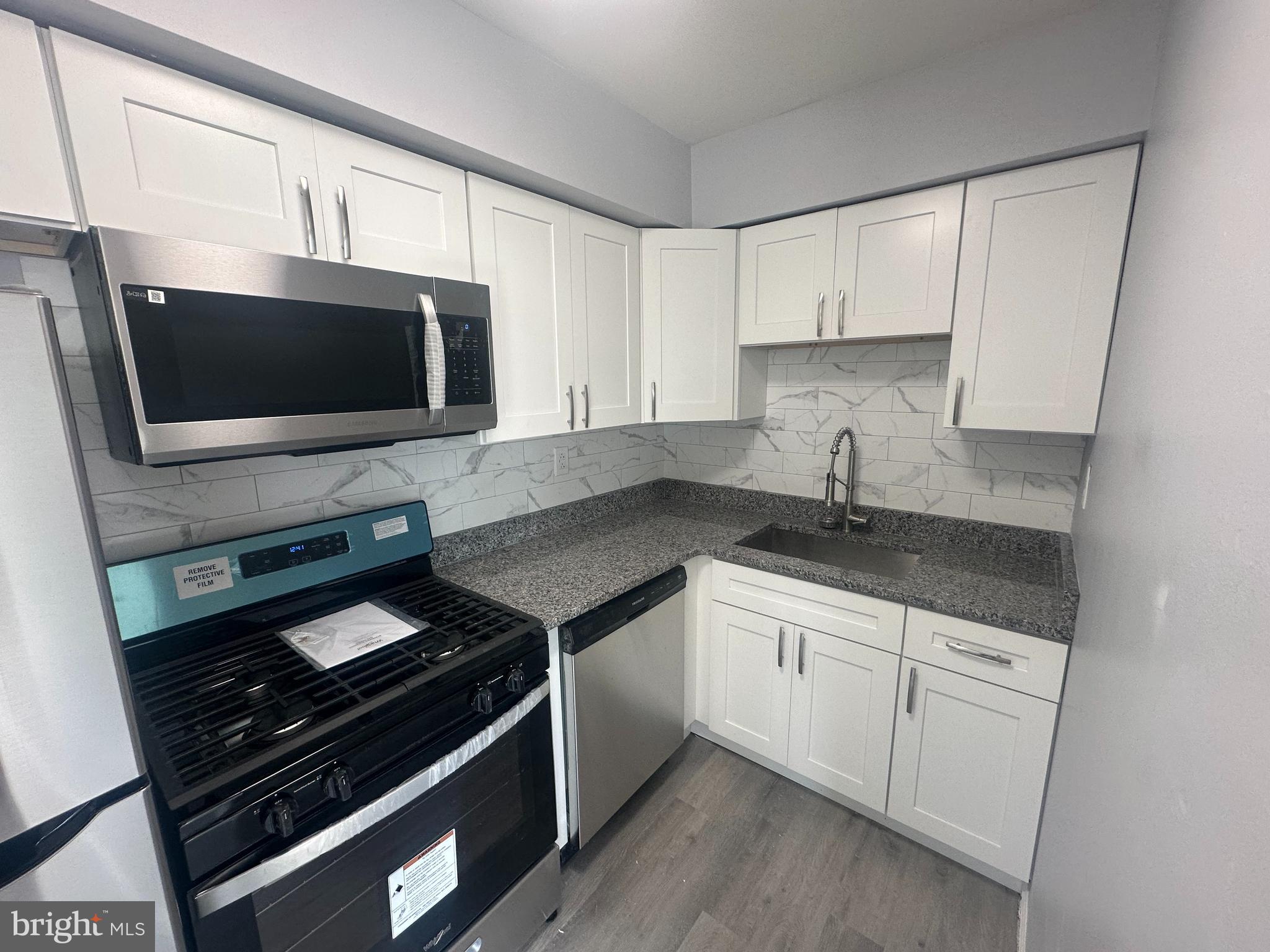 18-20 Thomas Road, Unit 18 Aston, PA 19014 - Photo 6 of 12 a kitchen with appliances a sink and cabinets