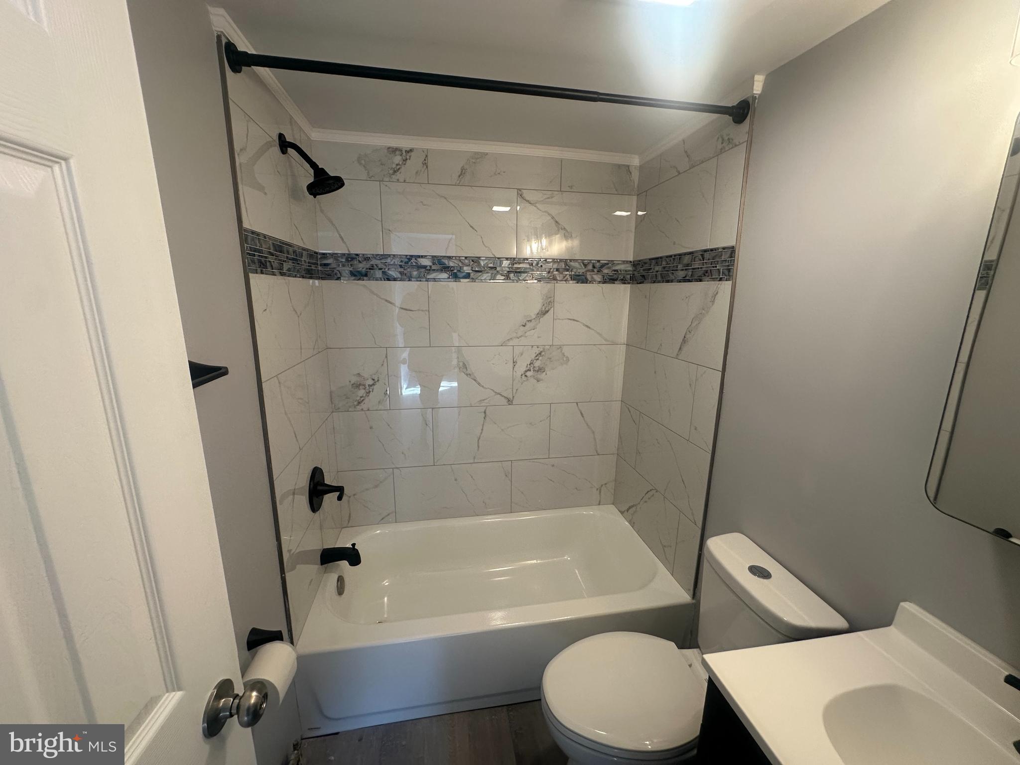 18-20 Thomas Road, Unit 18 Aston, PA 19014 - Photo 7 of 12 a bathroom with a bathtub shower and toilet