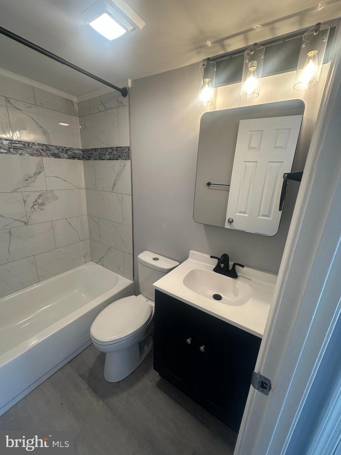 18-20 Thomas Road, Unit 18 Aston, PA 19014 - Photo 9 of 12 a bathroom with a toilet sink and mirror